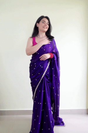 Royal Purple Satin-Finish Saree with Silver Border Detailing and Subtle Polka Embellishments Paired with Sleeveless Magenta Blouse